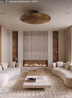 a living room filled with white furniture and a fire place in the middle of it