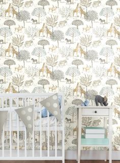 a baby's room with wallpaper and a crib in the foreground