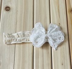 Delicately made, this beautiful lace bow headband is perfect for your little's special event.  Featuring soft and stretchy lace, completed by elegant bow details. White Lace Headband For Party, Elegant Lace Hair Accessories With Matching Headband, White Lace Party Headband, White Lace Wedding Headband, Cream Hair Accessories With Matching Headband For Baptism, Christening Headband Baby Girl, Adjustable White Lace Hair Accessories, Cream Baptism Headband Hair Accessory, Baby Lace Headband