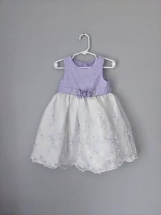 "Adorable Sophie Rose embroidered dress, size 24 months. The dress has a purple top with a gorgeous sheer overlay on the white skirt. The skirt is embroidered with flowers and a scalloped hem. So cute! The dress has a layer of tulle for a extra volume at the hem. In great condition. Size 24 months Waist: 11\" Length: 21\" I strive to describe each item as accurately as possible. Please check out the photographs, as they are a vital part of the descriptions. Don't hesitate to start a conversation Summer Purple Dress For Baptism, Purple Summer Baptism Dress, Purple Floral Applique Summer Dress, Summer Baptism Purple Dress, Summer Purple Dress With Floral Applique, Rose Embroidered Dress, Vintage Girls Dresses, Vintage Cape, Sheer Overlay