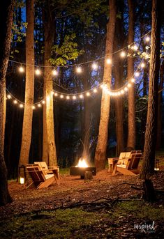 some chairs are lit up by string lights in the woods