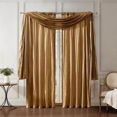 a living room with gold curtains and a chair