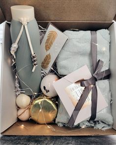 an open box with towels, ornaments and other items in it sitting on a table