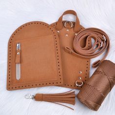 a brown leather case with two tassels and a wallet