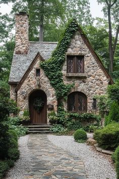 a stone house with ivy growing all over it