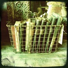 a basket filled with books sitting on top of a floor