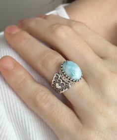 Blue Larimar Silver Women Statement Ring, Sterling Silver Designer Handmade Filigree Minimalist Love Ring, Oval Cocktail Ring Gift for Her Bridesmaid jewelry, handmade jewelry, silver band ring, wedding gift her Material: 925 Sterling Silver ( NICKEL FREE ) Gemstone: Larimar 10x14 mm. Larimar, it is the natural birthstones of those born "as the world awaits the vernal equinox and spring. This is a time when new life is about to burst forth, a time of faith and trust. FREE, FAST AND TRACKABLE SHIPPING FOR ALL EU COUNTRIES AND USA. -Fall in love with this Larimar silver oval victorian heart love ring. This sterling silver jewelry features a hand-crafted victorian style filigree, heart detail and a shiny oxidized finish. -The most romantic looking wedding ring is this Larimar Silver Boho Vict Blue Sterling Silver Filigree Ring, Elegant Oval Larimar Rings, Silver Band Ring Wedding, Luxury Blue Larimar Ring, Unique Silver Larimar Rings, Adjustable Blue Larimar Ring, Blue Larimar Cabochon Rings, Vernal Equinox, Filigree Heart