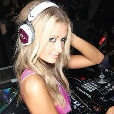 a woman with headphones on mixing music