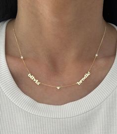 This adorable mini name necklace now comes with diamonds in between each name! Price is based on how many names you enter. Goes up as you enter more names. Example: if entering 4 names, select 4 for # of names. If you want to order one with a date, please use dashes ONLY in between the numbers. EXAMPLE: 14K Yellow Gold, 3 names, 4 diamonds - $1600 Name #1: zoey Name #2: max Name #3: jagger 2 names: 1 or 3 diamonds - if 1 it will be in between the name, if 3 it will be on every side of the names Two Name Necklace, White Diamond Nameplate Necklace, Diamond Nameplate Necklaces, Customized Diamond Name Necklace, Customizable Diamond Nameplate Necklace, Customizable Diamond Name Necklace For Personalized Gift, Customized Elegant Diamond Name Necklace, Personalized Diamond Name Necklace In White, White Diamond Name Necklace