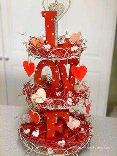 a three tiered valentine's day cake decorated with hearts