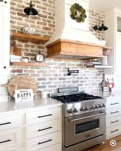 a stove top oven sitting inside of a kitchen next to white cabinets and counter tops