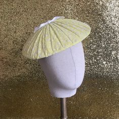 This sweet little 'plateau' style cocktail hat has been inspired by styles of the 1950s. The hand-blocked buckram base has been covered with a layer of crepe before being carefully overlayed with a hand-pleated layer of genuine vintage 1950s flocked organza in cheerful sunshine yellow with a scattering of tiny flowers all over it and topped off with a sweet little bow in white grosgrain ribbon - simply adorable! The hat has been fitted with a handmade wireframe that gently grips the head keeping Retro Party Hats For Spring, Retro Party Hat For Spring, Retro Brimmed Fascinator For Parties, Retro Fitted Brimmed Mini Hats, Retro Fitted Summer Fascinator, Retro Spring Fascinator Hat, Retro Spring Fascinator, Retro Fitted Fascinator For Kentucky Derby, Retro Short Brim Fascinator For Kentucky Derby