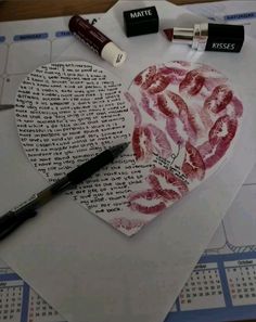 a heart shaped piece of paper with lipstick on it