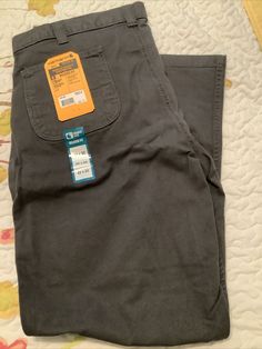 This pair of Carhartt Flex Canvas Work Pants is perfect for any man who wants a comfortable and stylish option for work or casual wear. Made with a cotton blend fabric that is easy to care for and machine washable, these pants feature a mid-rise waist and a relaxed leg style that provides a classic and versatile look. The pants come in a size 42x32 and have a solid gray color with a logo accent. They also have various pockets, including cargo pockets and 5-pocket design, making them practical for carrying essentials. Whether you're working in a warehouse or running errands, these Carhartt Flex Canvas Work Pants will become a staple in your wardrobe. Big And Tall Cotton Bottoms With Side Pockets, Big And Tall Straight Leg Cotton Jeans, Canvas Work Pants, Mens Rugged, Canvas Work, Carhartt Mens, Work Pants, Pocket Design, Running Errands