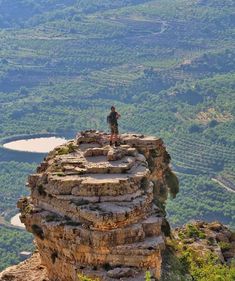 a man standing on the edge of a cliff