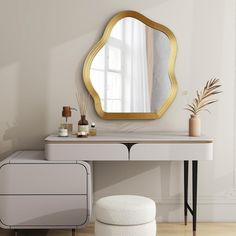 a dressing table with a mirror, stool and potted plant