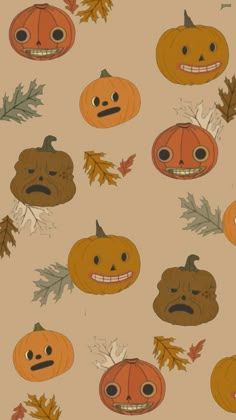 pumpkins and leaves with faces drawn on them