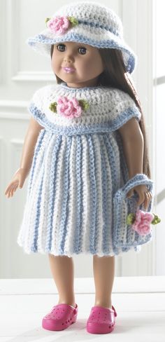 the doll is wearing a dress and hat