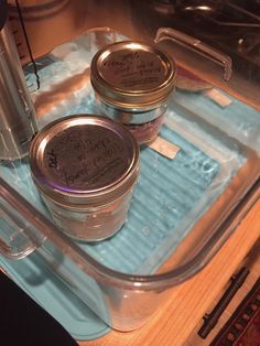 two jars of ice cream sitting on top of a blue tray