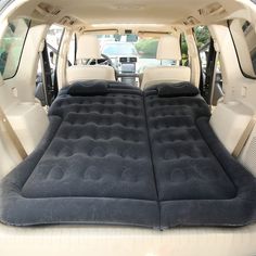 an inflatable mattress is placed on the back of a car