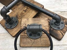 three wooden coasters with metal handles and knobs on them, one has a black ring