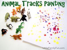 small toy animals are scattered on top of a white paper with confetti sprinkles