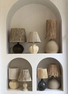 a shelf with lamps and vases on it