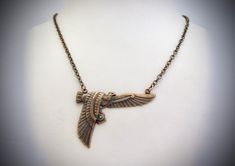 "Vintage Art Nouveau design Egyptian Revival Bird Pendant Necklace. A fabulous Horus falcon design, with a tiny sparkling rhinestone accent. Beautiful Antiqued brass. Ornate detailed bird, 2-1/8\" across. Antiqued brass finish brass chain with a lobster clasp. Sent to you with Aloha! #91 More of my Artisan Jewelry: hawaiibeads.etsy.com" Handmade Metal Necklace For Cosplay, Handmade Metal Necklaces For Cosplay, Adjustable Fantasy Necklaces For Fantasy Events, Adjustable Fantasy Necklace For Fantasy Events, Fantasy Bronze Metal Jewelry, Steampunk Silver Jewelry For Cosplay, Bronze Metal Fantasy Necklace, Adjustable Fantasy Necklaces For Cosplay, Fantasy Style Bronze Metal Necklace