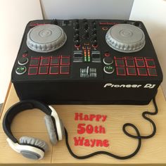 a birthday cake with headphones and a dj's tape recorder on the side