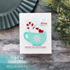 a close up of a greeting card with a cup of coffee on it and candy canes