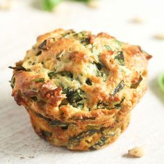 three muffins stacked on top of each other with spinach leaves in the background