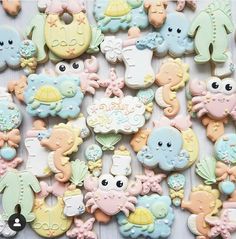 there are many different decorated cookies on the table in this photo, including one for baby's first birthday