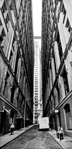 an empty city street with tall buildings in the background