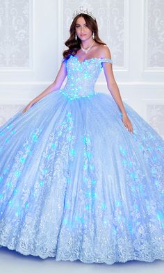 Wear this majestic quinceañera dress, from Princesa by Ariana Vara, for a show-stopping look both day and night. Glimmering beading and stone accents, as well as a voluminous glitter tulle skirt, catch the sun for daytime ceremonies, while matching lights in the bodice and skirt make this glow-in-the-dark quinceañera eye-catching for twilight parties. Glamorous embroidered lace highlights the bodice and wraps around the bottom of the poofy skirt on this quince ball gown. The detachable sleeves o Glamorous Sequin Quinceanera Dress For Prom Season, Blue Embellished Quinceanera Dress For Party, Embellished Blue Quinceanera Dress For Party, Embellished Princess Style Quinceanera Dress, Blue Sequin Quinceanera Gown, Blue Sequin Gown For Quinceanera, Blue Sequined Ball Gown For Quinceanera, Glamorous Sequined Quinceanera Ball Gown, Glamorous Sequined Ball Gown Quinceanera Dress