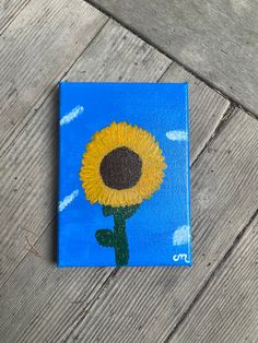 a painting of a sunflower on a blue background