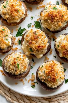 stuffed mushrooms with cheese and parmesan on a white platter, garnished with parsley