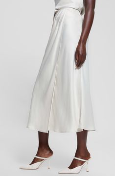 Soft pleats texture this wrapped maxi skirt elevated in luxe satin. 36 1/2" length Side zip closure Unlined 58% recycled polyester, 42% polyester Hand wash, line dry Imported Midi Satin Skirt, Satin Wrap Skirt, Satin Maxi Skirt, Wrap Maxi Skirt, Satin Midi Skirt, Satin Maxi, Recycled Bottles, Satin Skirt, White Skirts