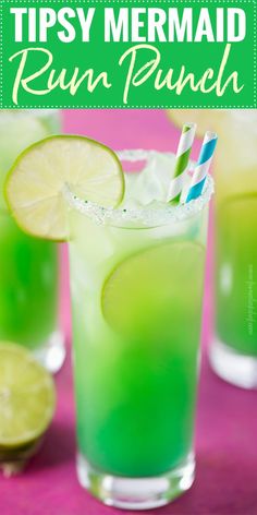 two glasses filled with green liquid and lime slices on the rim, next to each other