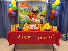 the table is set up with balloons and decorations for children's birthday party at school