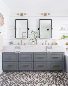 a bathroom with two sinks and mirrors on the wall