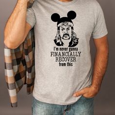 a man wearing a mickey mouse t - shirt with the words i'm never going to financially recover from this