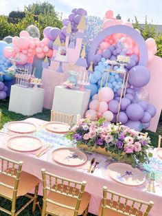 a table set up for a princess birthday party with balloons and flowers on it,