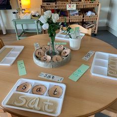 the table is set up with cookies and place cards for each individual to put on