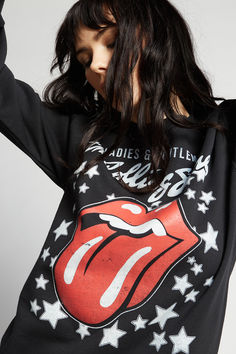 Our next band needs no introduction. This bold graphic sweatshirt features the band's iconic lips and tongue logo with the title of their 1974 movie "Ladies & Gentlemen: The Rolling Stones". Made with soft washed fabric, a crew neckline, ribbed hems, and a slightly fitted style. The Black Crowes, Joan Jett, Billy Joel, Original Fashion, Janis Joplin, Def Leppard, Black Sabbath, Boyfriend Tee, Workout Sweatshirt