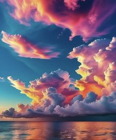 the sky is filled with colorful clouds over the water