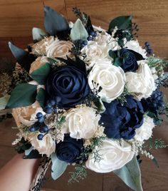 a bridal bouquet with blue and white flowers