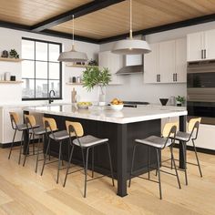 a large kitchen with white cabinets and black counter tops is pictured in this image, there are many chairs around the island