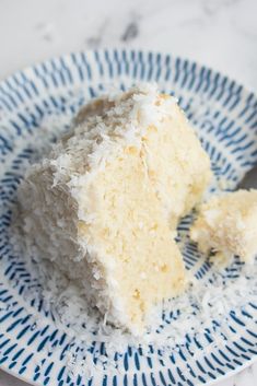 a piece of coconut cake on a blue and white plate