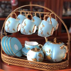 there are many tea cups and saucers on the tray