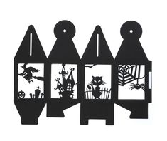 three pieces of paper cut out to look like houses with bats and witches on them